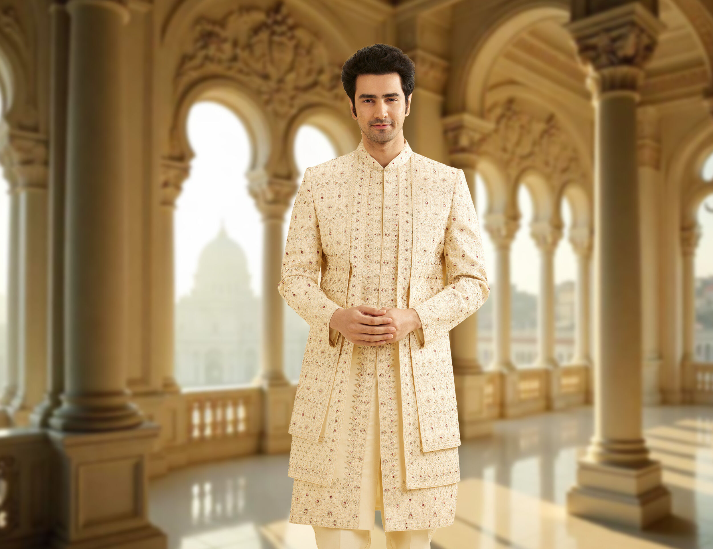 Elegant men wearing traditional cream-colored kurta sets, showcasing regal Mughal design influences